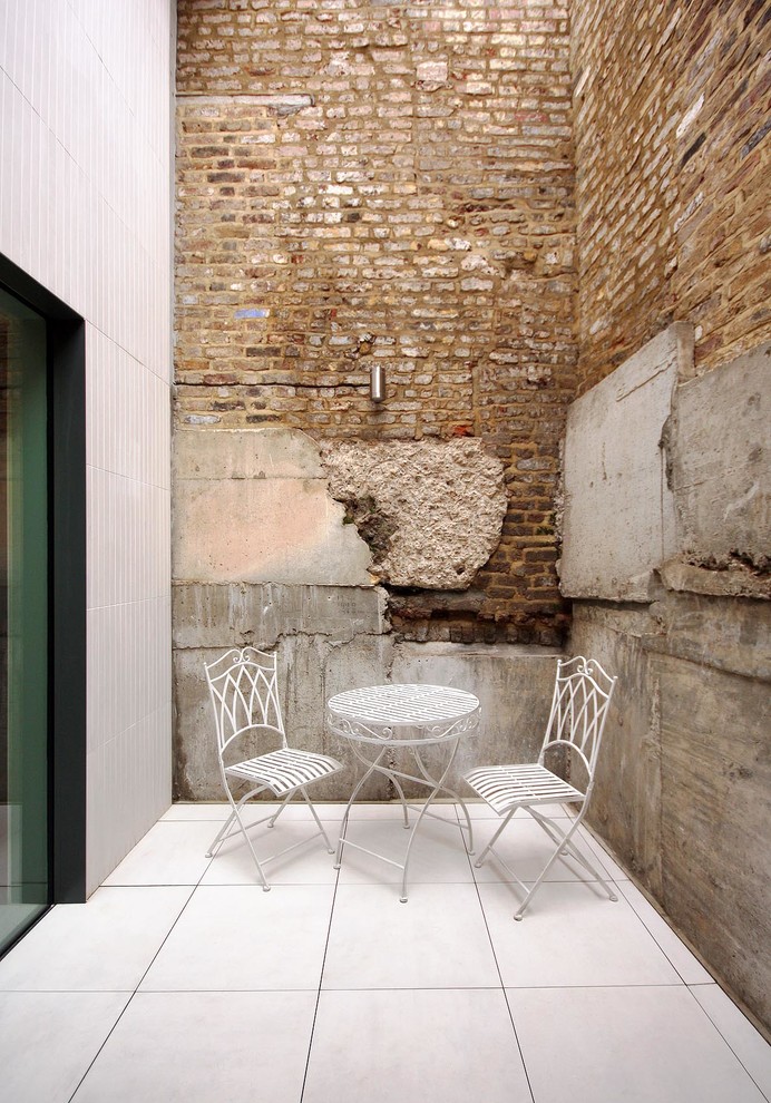 Patio - small contemporary patio idea in London with no cover