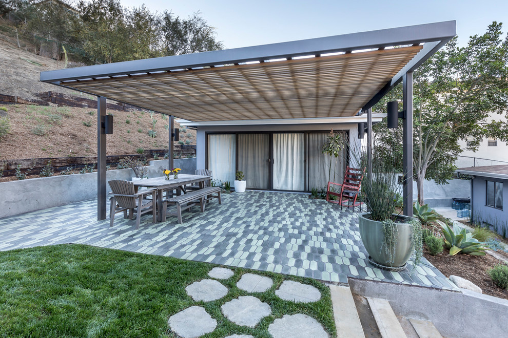 Inspiration for a medium sized country back patio in Los Angeles with tiled flooring and an awning.
