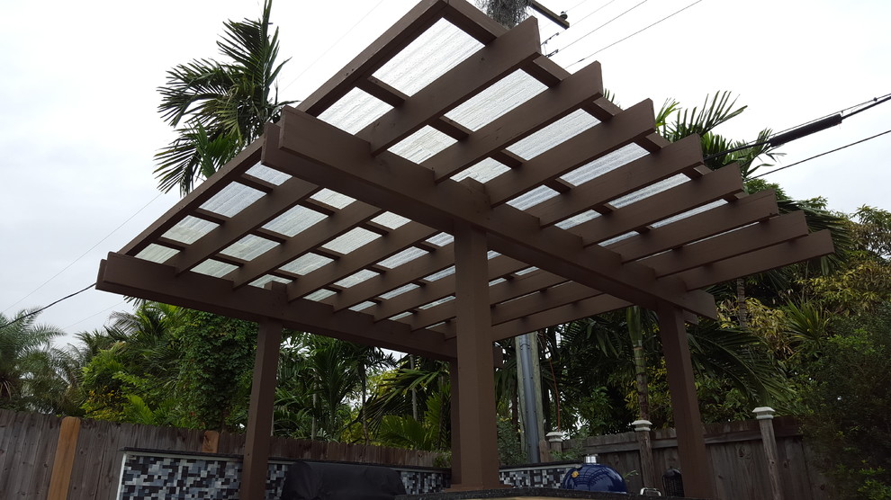 Photo of a medium sized contemporary back patio in Miami with an outdoor kitchen and a pergola.