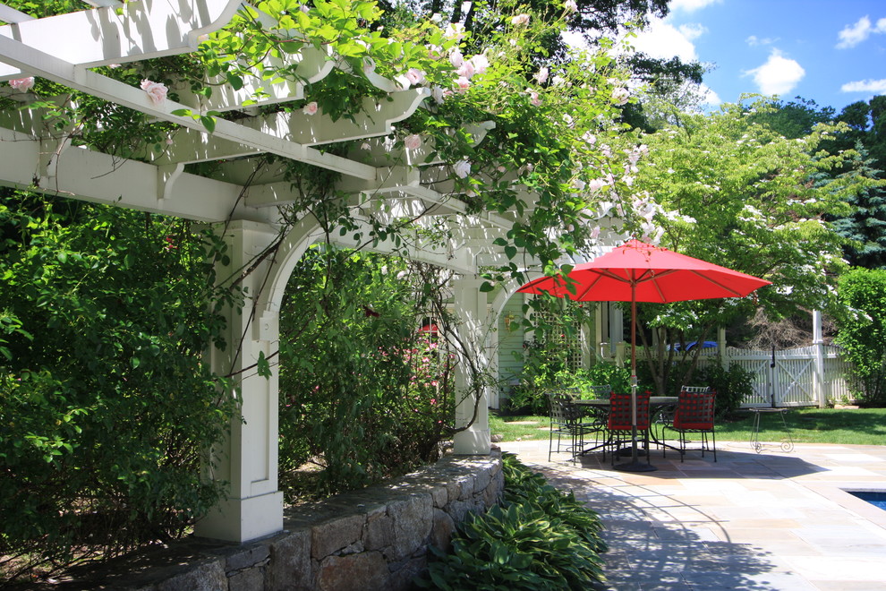 Inspiration for a timeless patio remodel in New York with a pergola