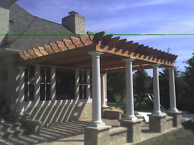 Photo of a medium sized contemporary back patio in Columbus with an outdoor kitchen, brick paving and a pergola.