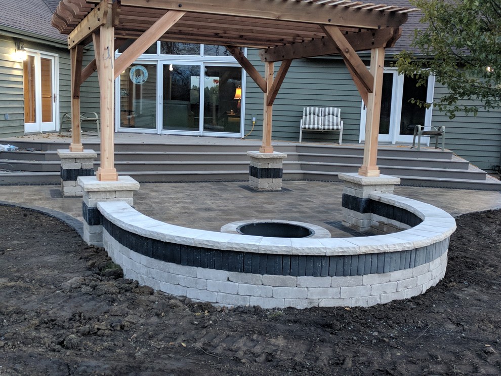 Patio - mid-sized transitional backyard stamped concrete patio idea in Chicago with a fire pit and a pergola