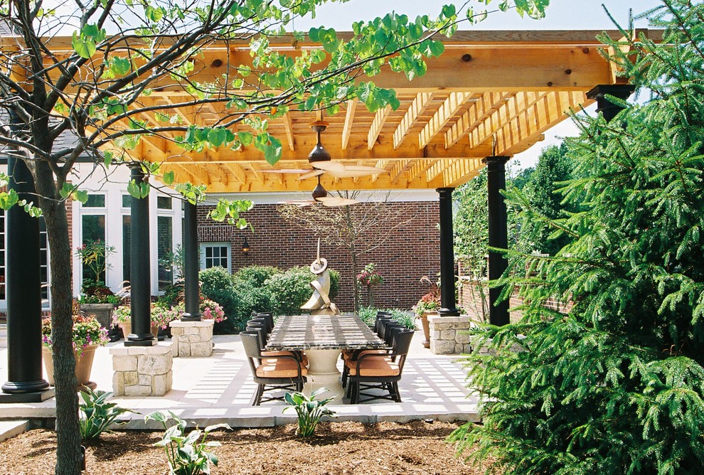 Design ideas for a large contemporary back patio in St Louis with concrete paving, a pergola and an outdoor kitchen.