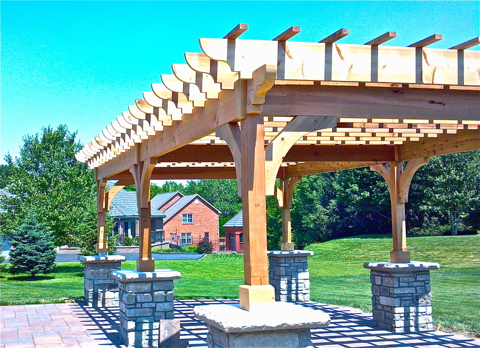 Inspiration for a large transitional backyard concrete paver patio remodel in St Louis with a pergola