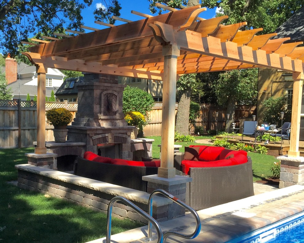 Example of a trendy backyard brick patio design in Chicago with a pergola