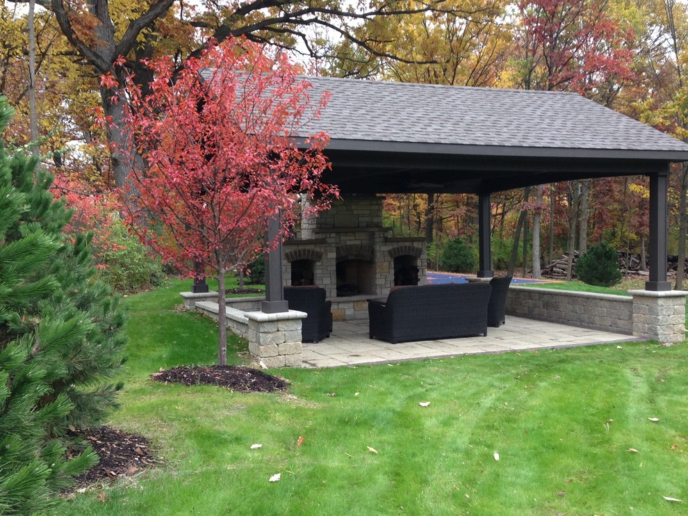 Photo of a medium sized classic back patio in Chicago with a fire feature, concrete paving and a gazebo.