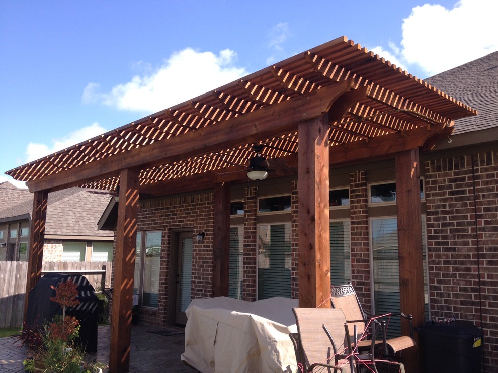 Design ideas for a small classic back patio in Houston with stamped concrete and a pergola.