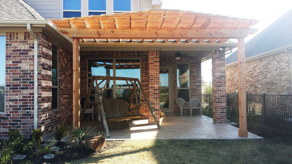 Inspiration for a small backyard concrete patio remodel in Houston with a pergola