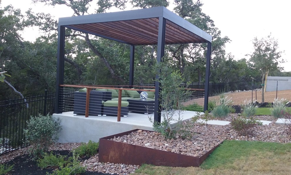 Inspiration for a medium sized back patio in Austin with concrete paving and a pergola.