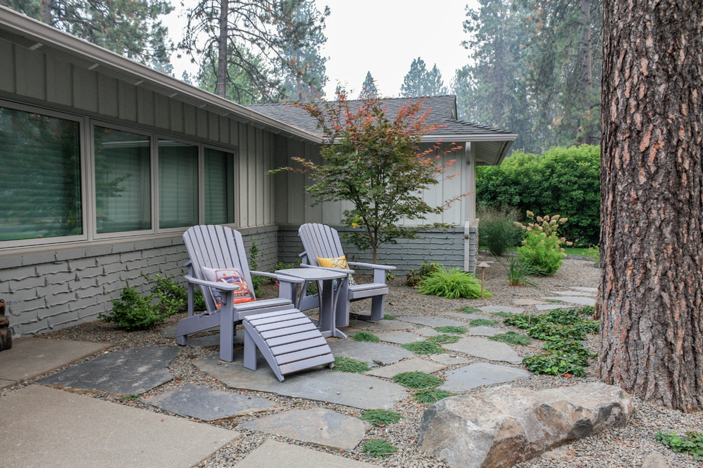 Design ideas for a small midcentury front patio in Seattle with natural stone paving and no cover.