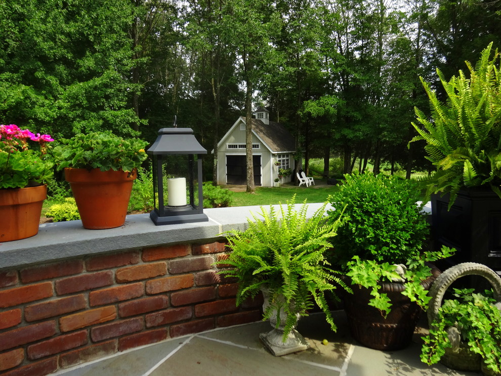 Diseño de patio clásico de tamaño medio en patio trasero con losas de hormigón