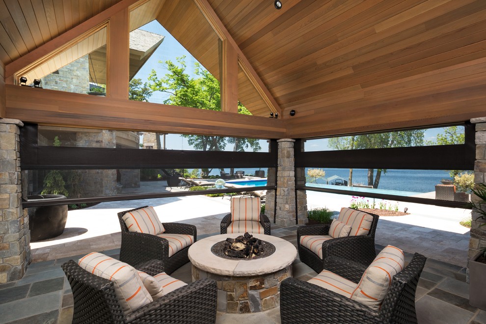 Design ideas for a large traditional back patio in Orlando with a fire feature and a pergola.