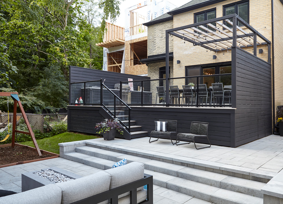 Источник вдохновения для домашнего уюта: большой двор на заднем дворе в стиле модернизм с мощением тротуарной плиткой и козырьком