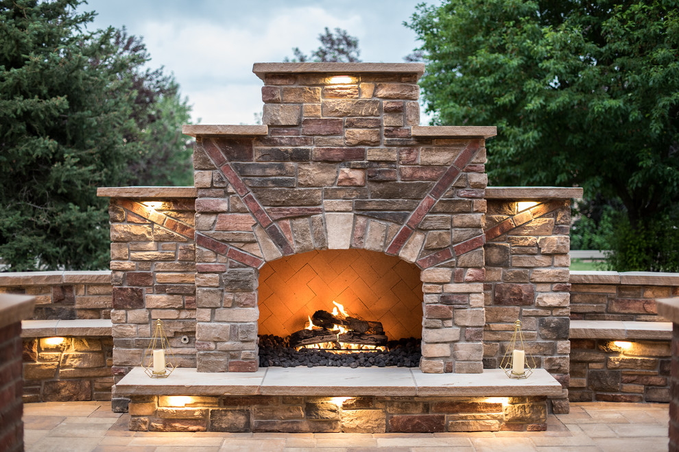 Mid-sized tuscan backyard stone patio photo in Denver with a fireplace and no cover