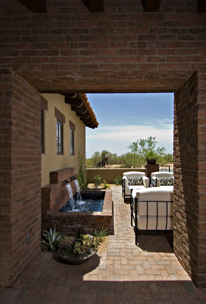 Photo of a mediterranean patio in Phoenix with a water feature.