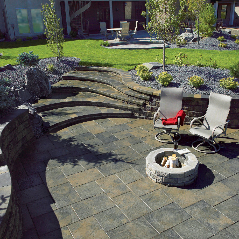 Mid-sized elegant backyard stone patio photo in Other with a fire pit and a gazebo