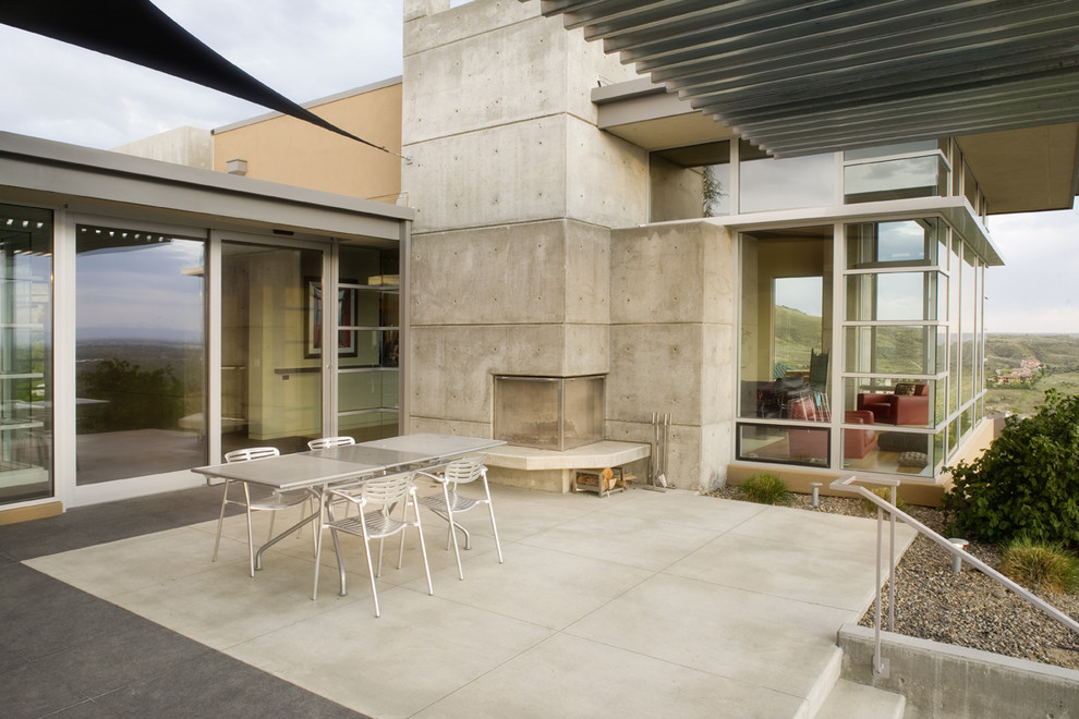 Aménagement d'une terrasse moderne avec un foyer extérieur.