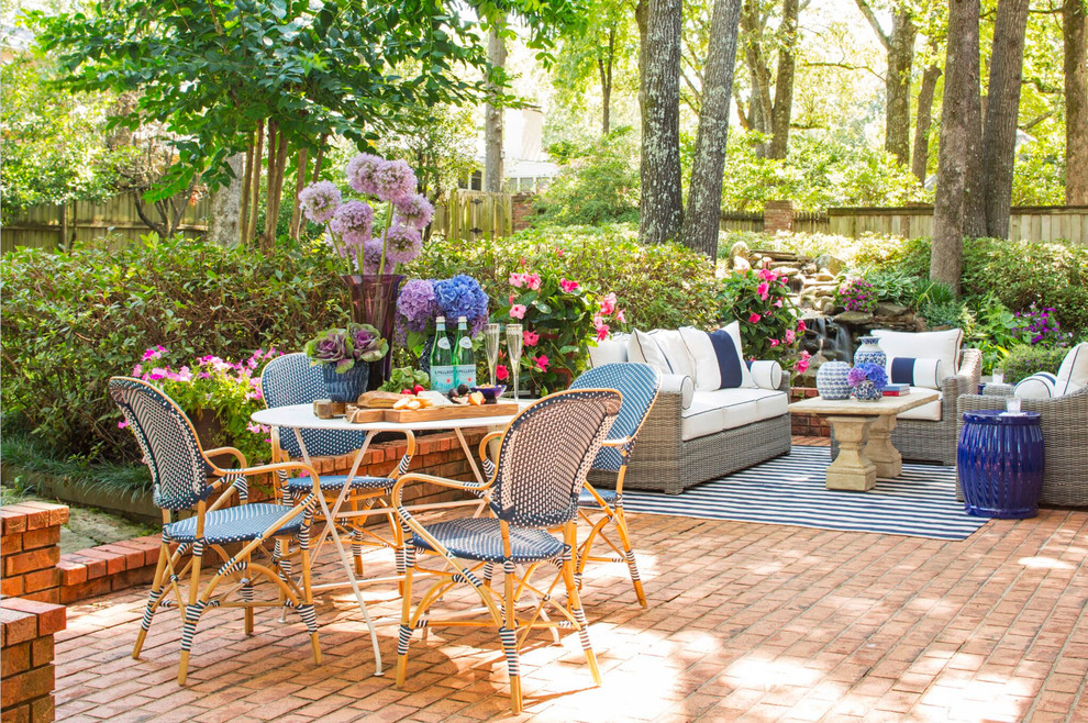 Inspiration for a mid-sized timeless backyard brick patio fountain remodel in Little Rock with no cover