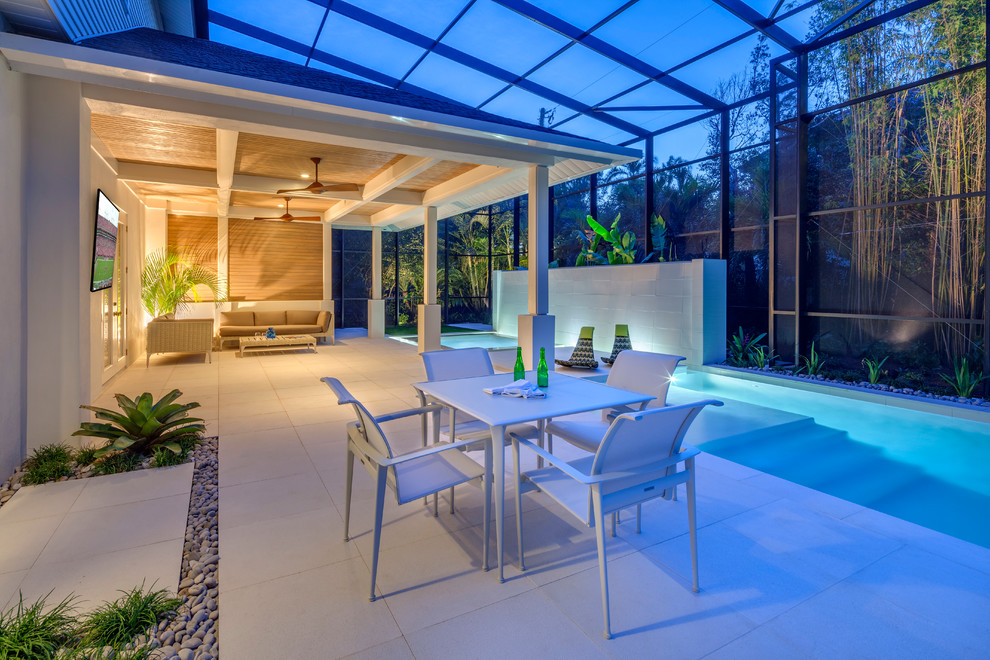 This is an example of a contemporary patio in Tampa with a water feature and all types of cover.