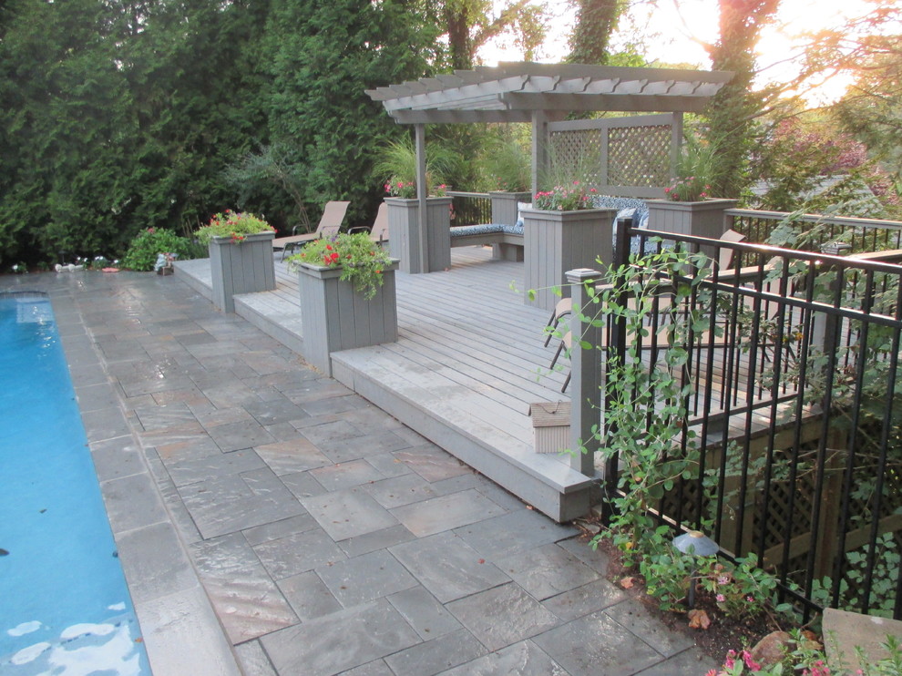 Patio - large traditional backyard patio idea in New York with decking and a pergola