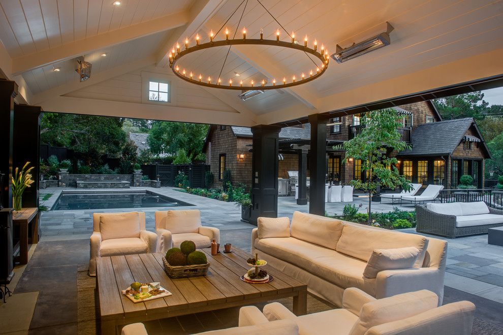 Design ideas for an expansive classic back patio in San Francisco with natural stone paving and a gazebo.