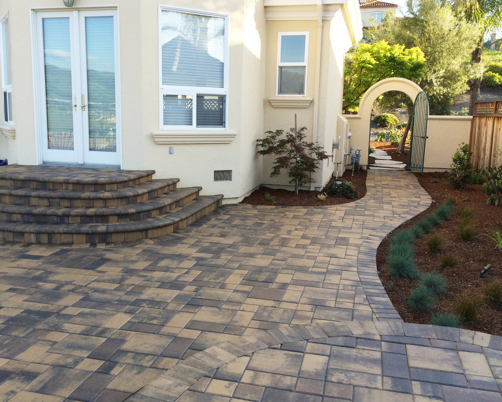 Example of a large tuscan backyard stone patio design in San Francisco with no cover