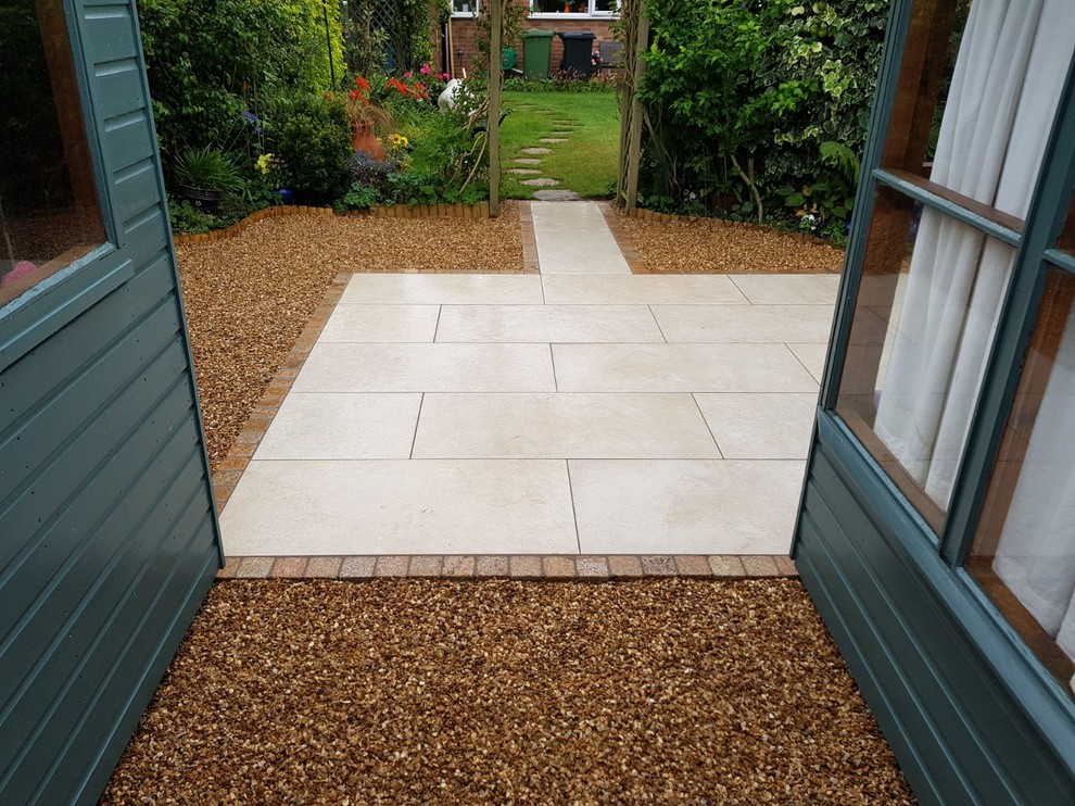 Medium sized modern back patio in Oxfordshire with tiled flooring and no cover.