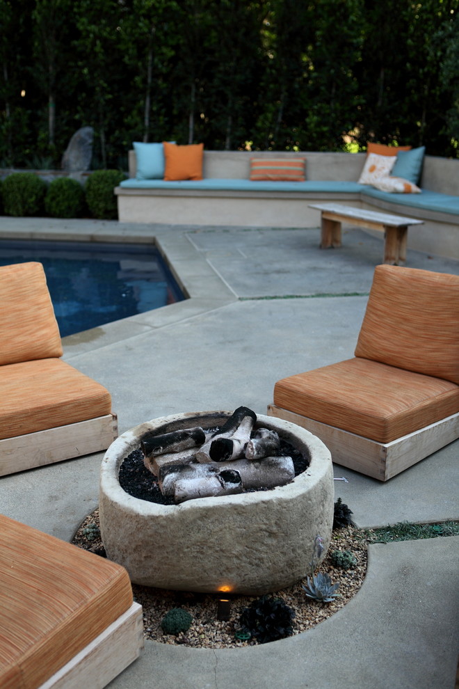 This is an example of a traditional patio in Orange County with a fire feature.