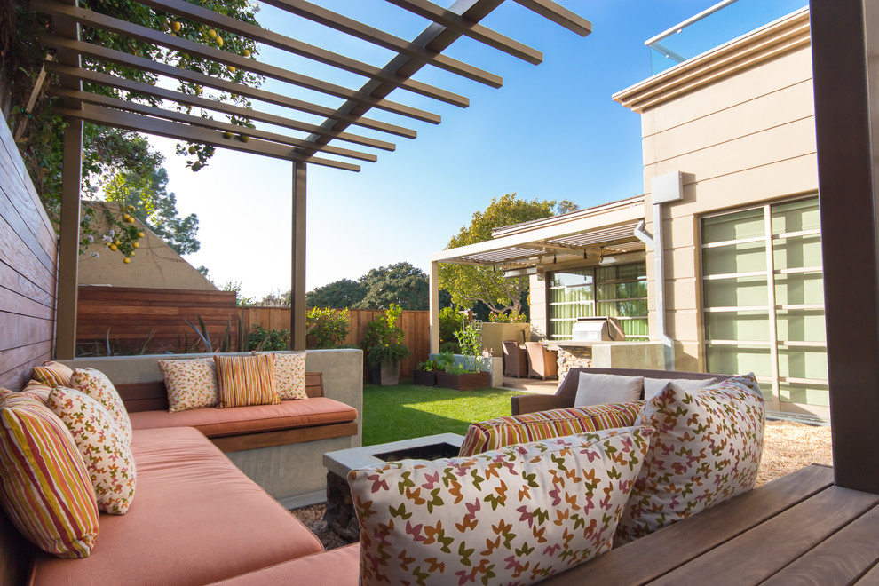 Photo of a medium sized contemporary back patio in Orange County with a fire feature and a pergola.