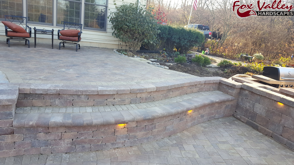 Medium sized modern back patio in Chicago with brick paving and no cover.