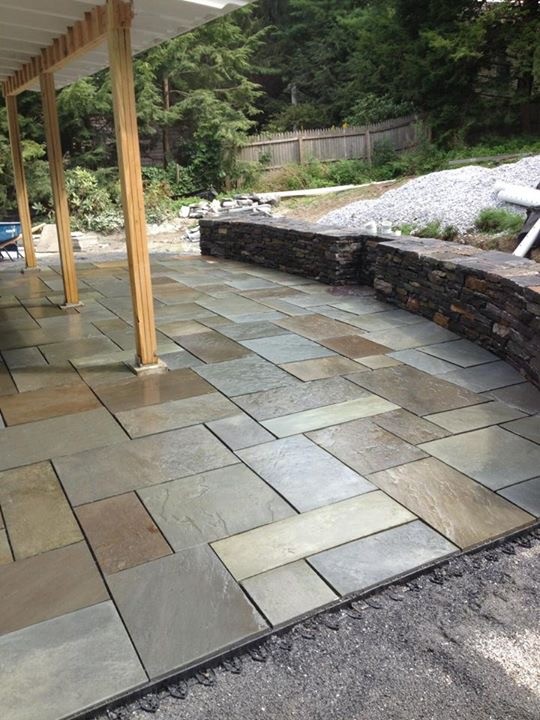 Example of a mid-sized backyard tile patio design in Burlington with a roof extension