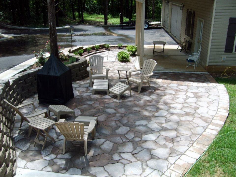Photo of a classic front patio in St Louis with brick paving and a roof extension.