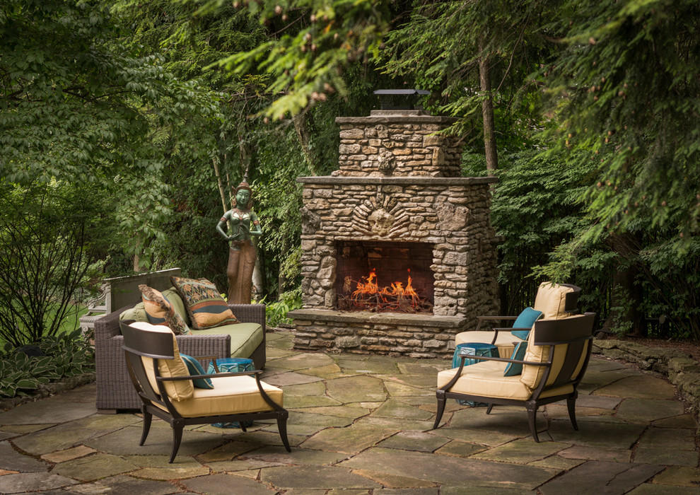Inspiration for a timeless stone patio remodel in Detroit with no cover and a fireplace