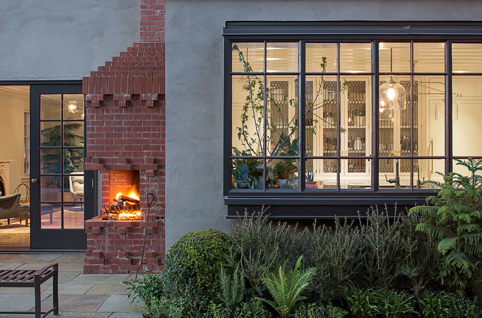 Mid-sized transitional backyard stone patio photo in Portland with a fire pit and no cover