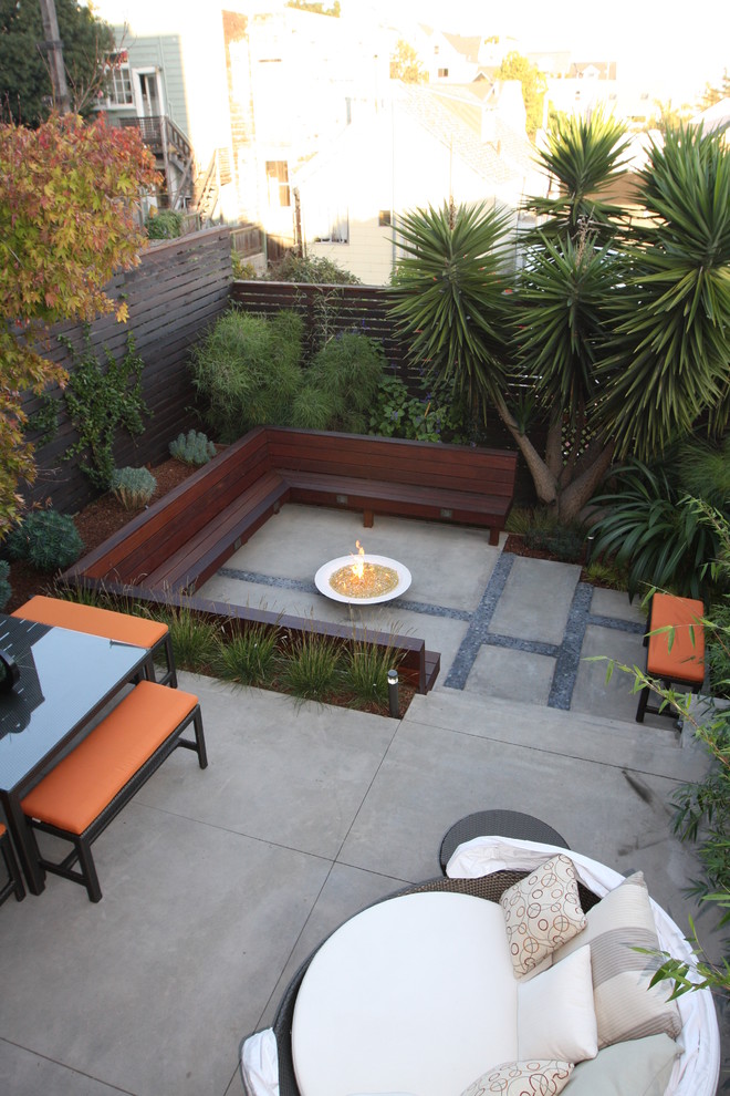 Idées déco pour une terrasse moderne avec un foyer extérieur, une dalle de béton et aucune couverture.