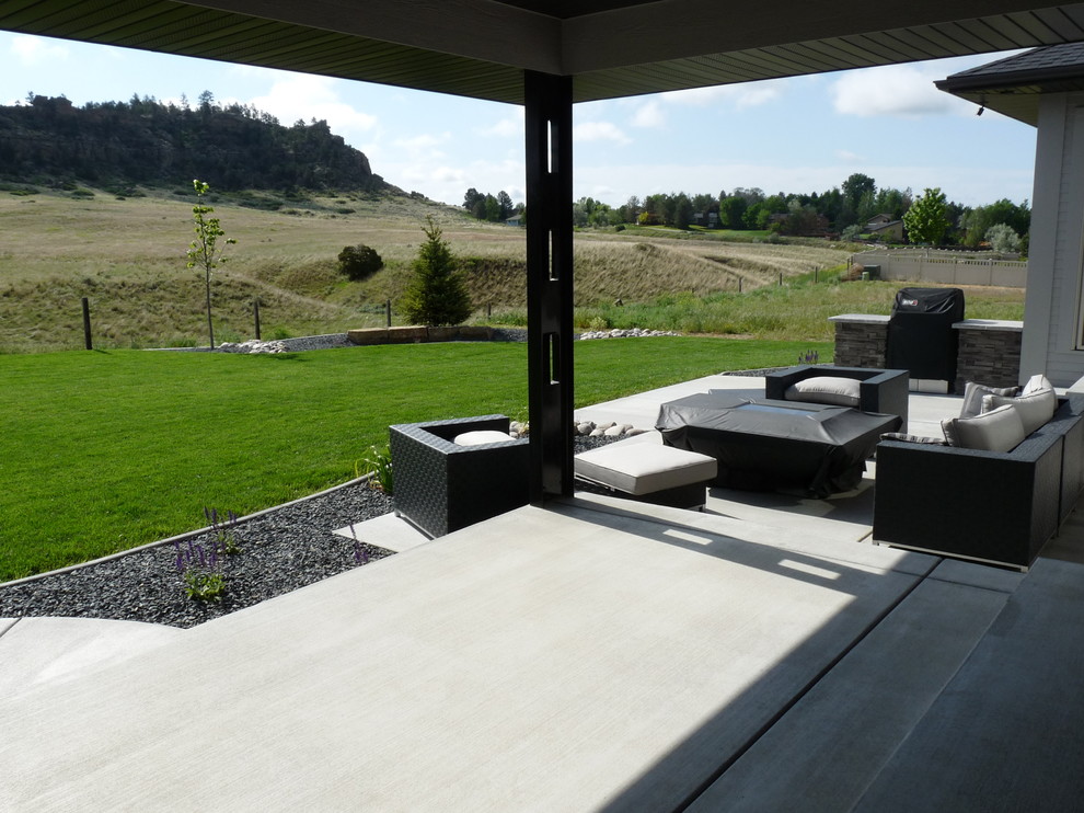 Patio - mid-sized contemporary backyard concrete patio idea in Other with a fire pit and a roof extension