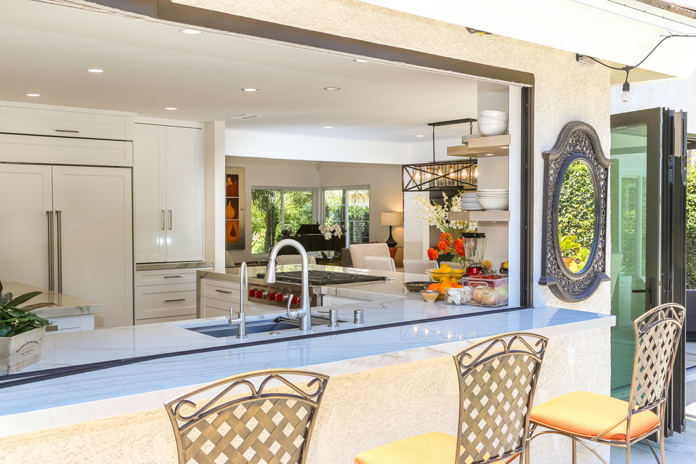Inspiration for a medium sized classic back patio in Orange County with an outdoor kitchen and no cover.