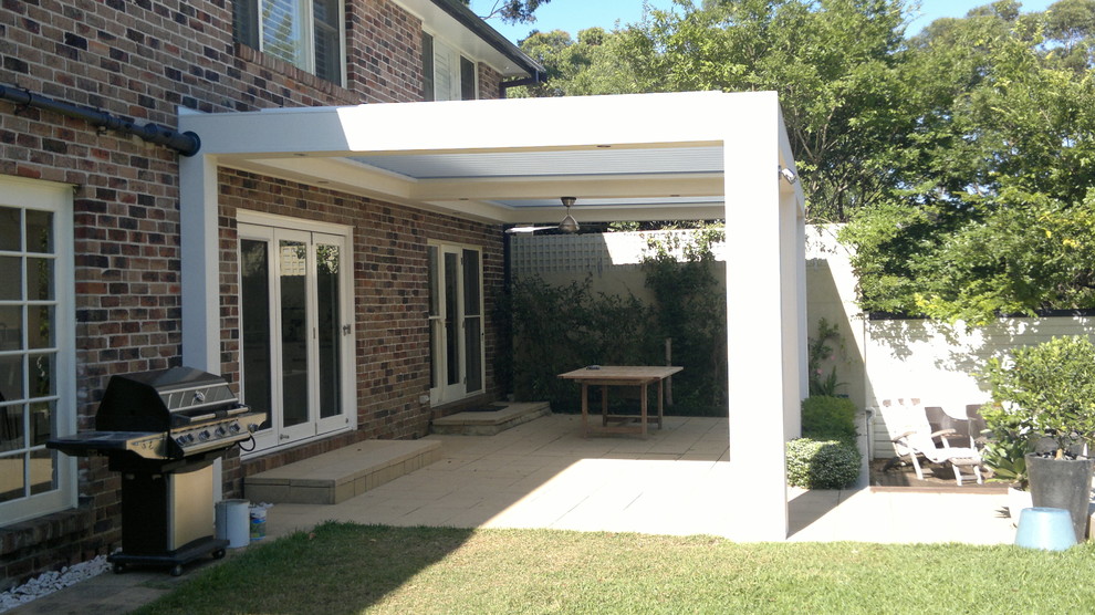 Design ideas for a large contemporary back patio in Sydney with brick paving and a pergola.