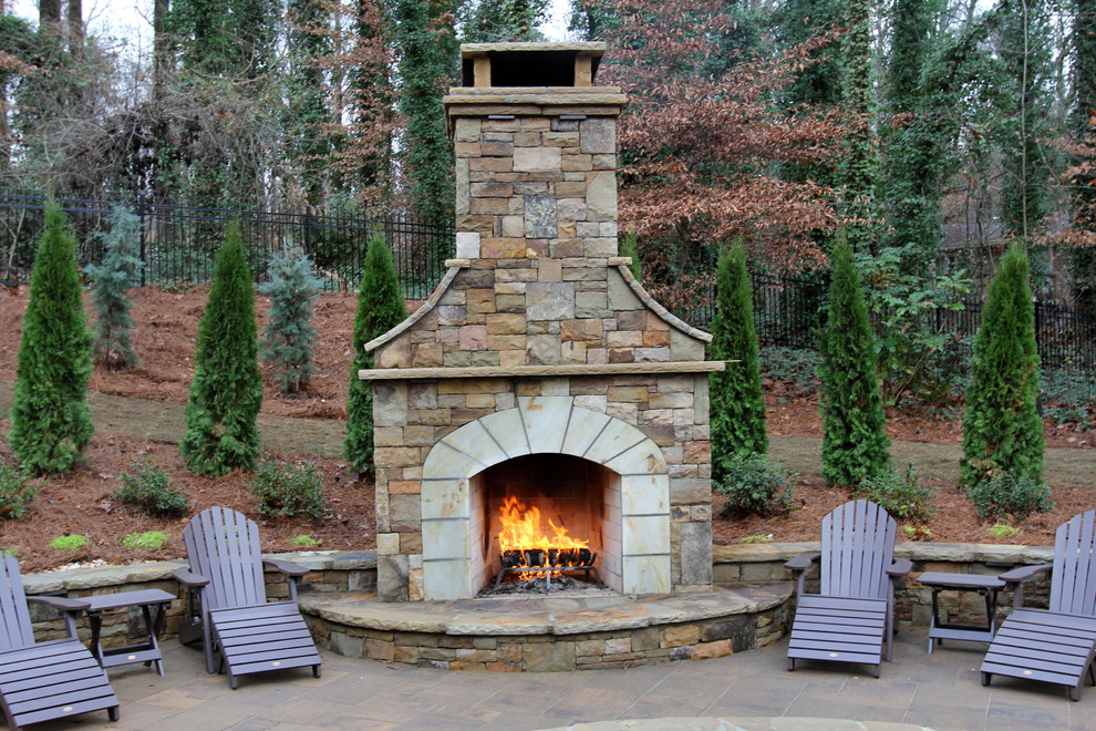 Example of a large classic backyard concrete paver patio design in Atlanta with a fire pit and no cover