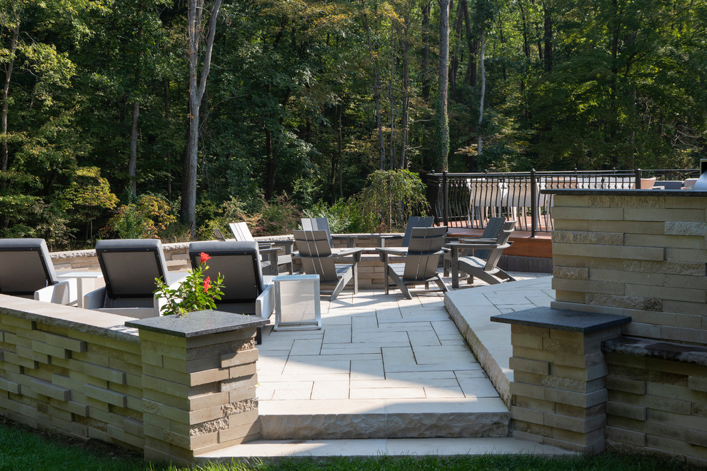 Design ideas for an expansive contemporary back patio in Other with an outdoor kitchen, natural stone paving and no cover.