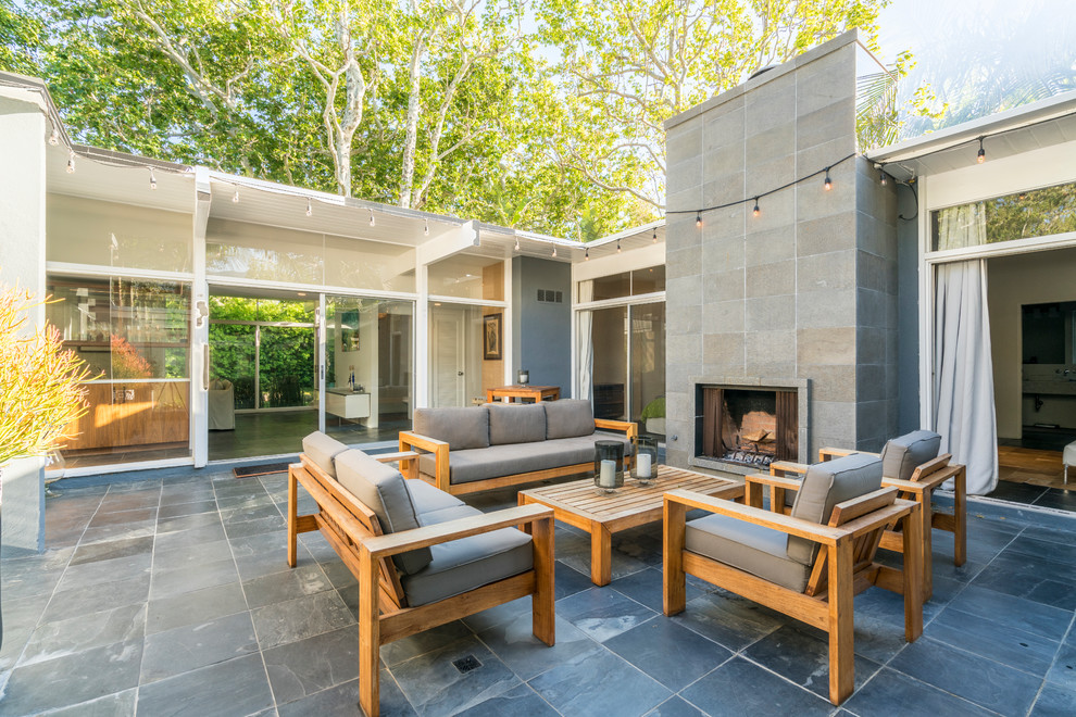 Contemporary back patio in Los Angeles with no cover.