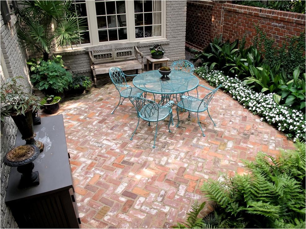 Mid-sized elegant brick patio photo in Other with no cover