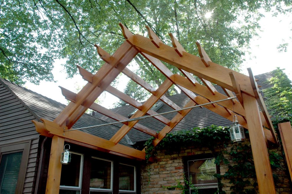 Example of a classic backyard patio design in Minneapolis with a pergola