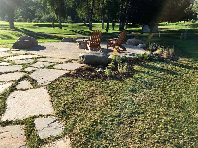 Inspiration for a small rustic backyard stone patio remodel in Albuquerque with a fire pit and no cover