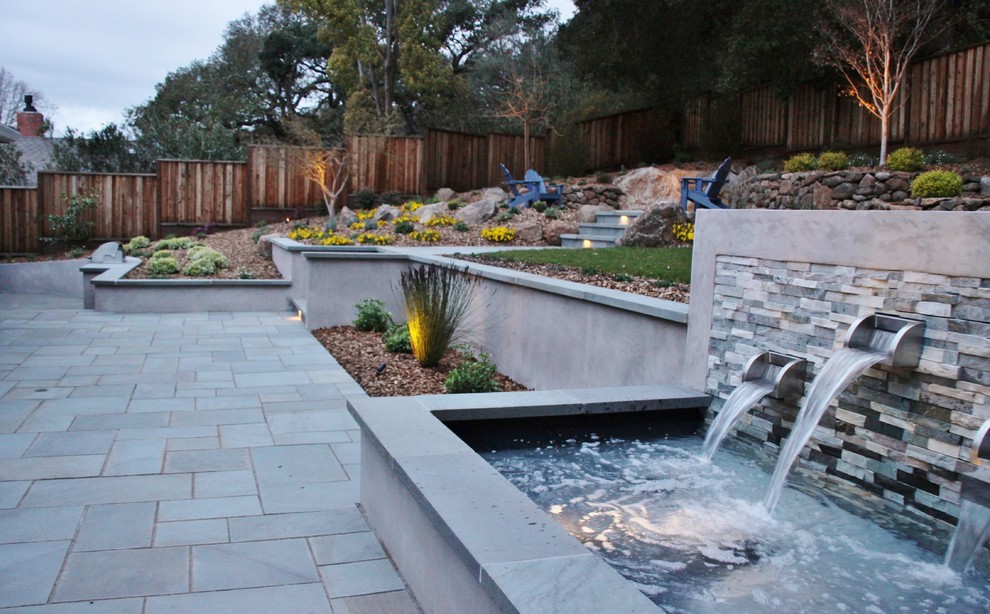 Design ideas for a large contemporary back patio in San Francisco with no cover, natural stone paving and a water feature.
