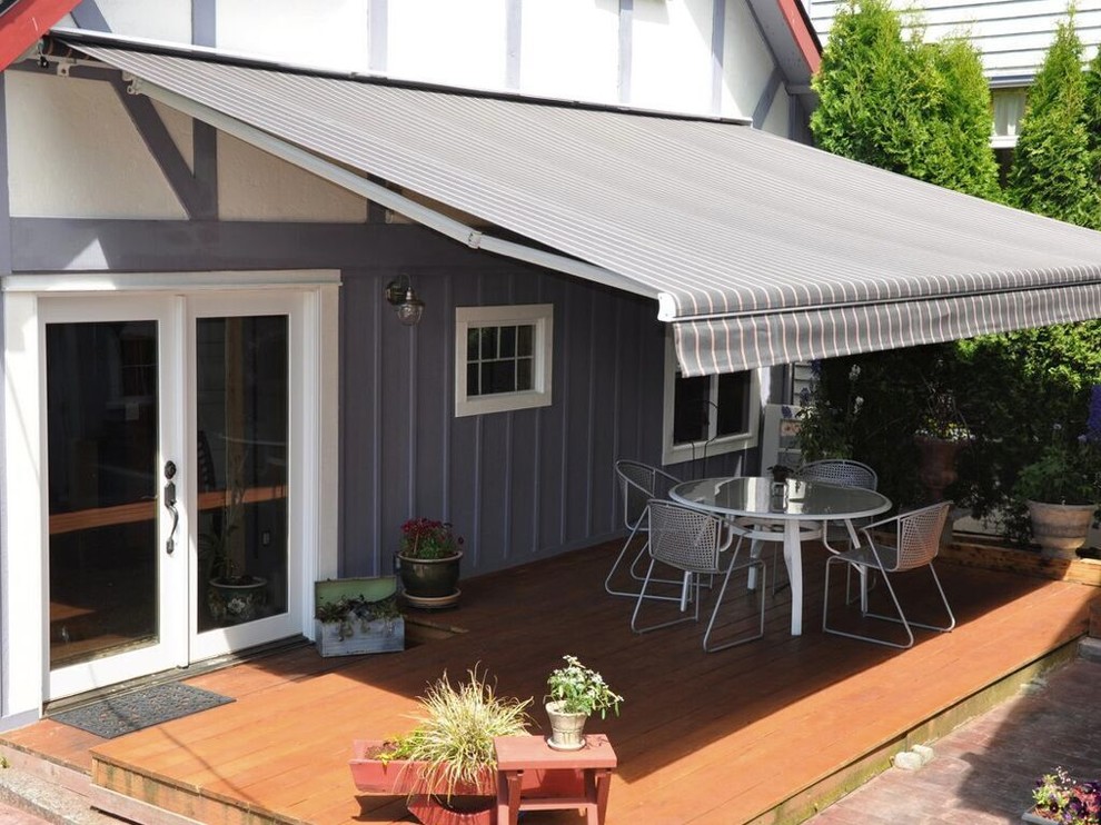 This is an example of a medium sized traditional back patio in Orange County with decking and an awning.