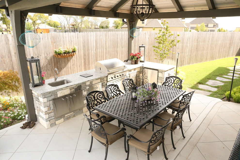 Inspiration for a large transitional backyard tile patio kitchen remodel in Other with a gazebo