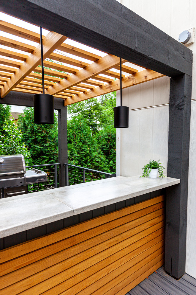 Inspiration for a large modern back patio in Minneapolis with an outdoor kitchen, decking and a pergola.