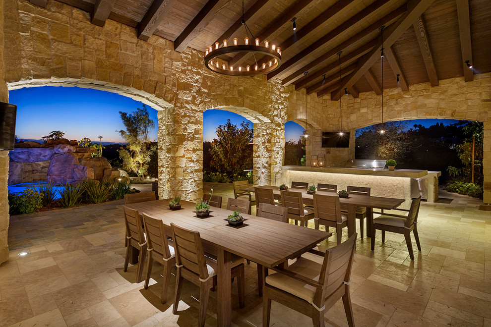 Large tuscan backyard brick patio kitchen photo in San Diego with a roof extension