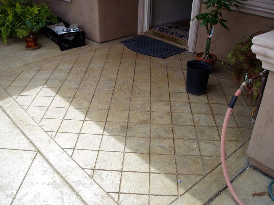 Small elegant backyard concrete paver patio photo in San Diego with a roof extension